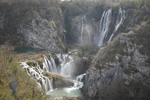       Multiple cascading waterfalls and turquoise lakes within the limestone cliffs of Plitvice Lakes National Park.
  