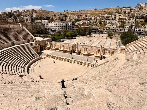       Sweeping view across the stone seating of Amman’s Roman Theater toward the modern city below.
  