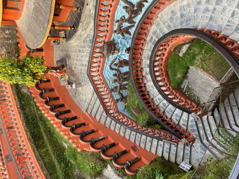       Spiral terracotta staircases and fountains form an ornate courtyard of a Hindu temple complex in Kathmandu.
  