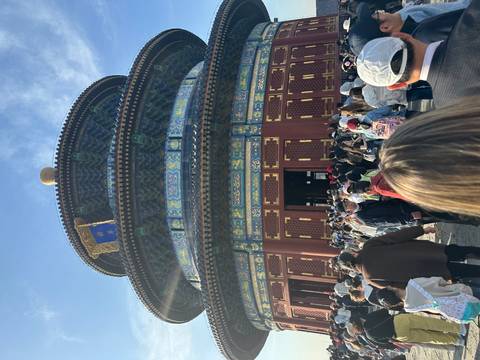       Visitors crowd around the richly decorated circular Hall of Prayer for Good Harvests at Beijing's Temple of Heaven.
  