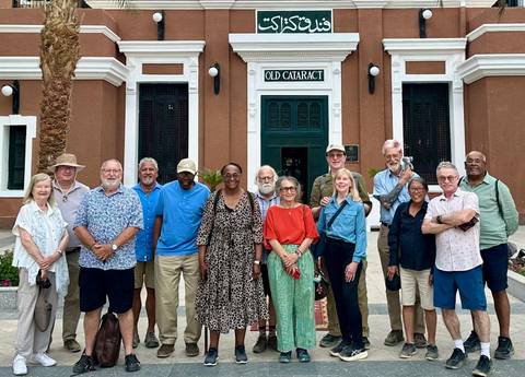       Group tour portrait in front of Old Cataract Hotel entrance in Aswan, Egypt.
  