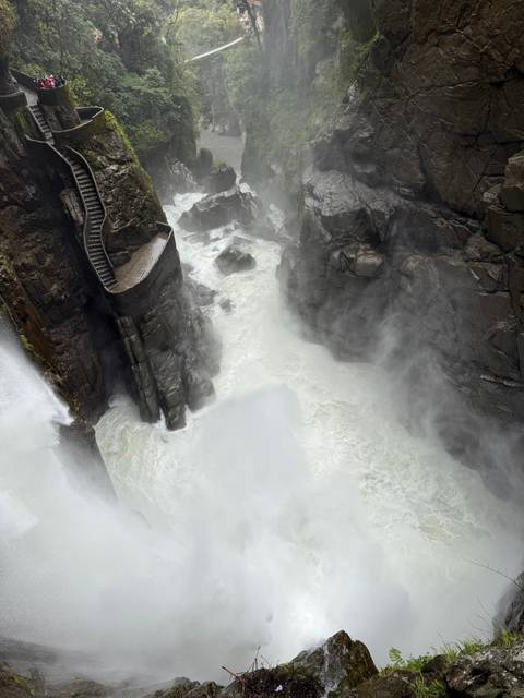       Powerful waterfall crashes through a steep rocky gorge sending mist into the air.
  