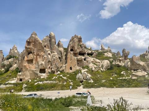       Eroded tufa rock dwellings with windows and caves carved into cliffs
  