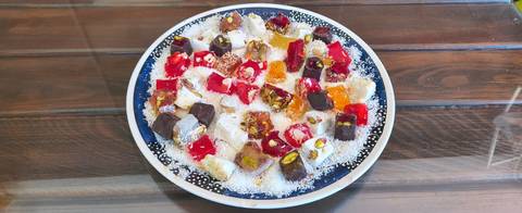       Plate of assorted colorful Turkish delight pieces dusted with coconut
  