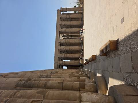       Rows of towering sandstone columns cast shadows across the courtyard of Luxor Temple.
  