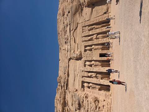       Tourists walking in front of the Small Temple at Abu Simbel with statues of Ramesses and Nefertari.
  