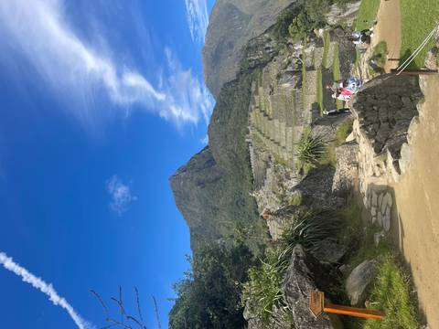       Stone terraces and rugged mountain backdrop at Machu Picchu under clear skies
  