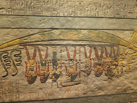       Colorful wall painting of ancient Egyptian figures aboard a boat, preserved with vivid detail.
  