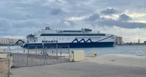       Seajets high-speed ferry docked at a Greek island port under gray skies
  