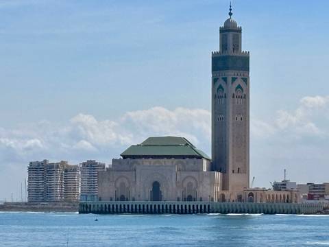       Iconic Hassan II Mosque and its towering minaret rise beside Casablanca's Atlantic shore.
  