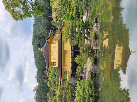       Golden Pavilion (Kinkaku-ji) reflected in a tranquil pond surrounded by greenery
  