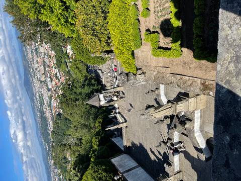      Baroque staircase of Bom Jesus do Monte descending toward panoramic views of Braga city below.
  