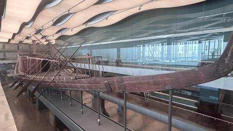      Ancient wooden solar barque displayed inside the museum near the Giza pyramids
  