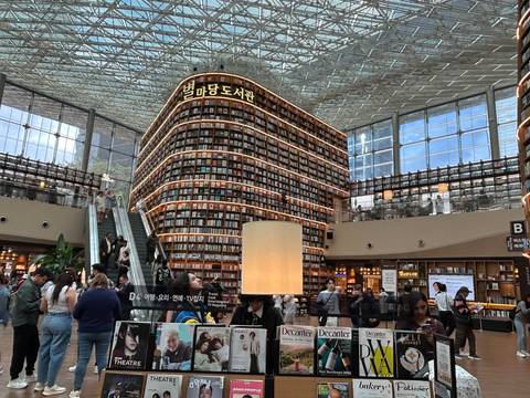       Interior of Starfield Library with towering book shelves and busy visitors
  