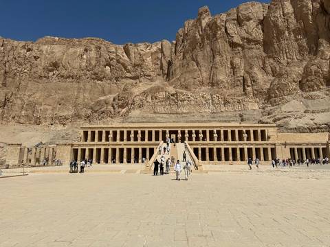       Impressive terraced façade of Hatshepsut’s mortuary temple set against towering desert cliffs.
  