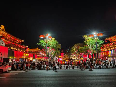       Lively night scene with illuminated traditional buildings and crowd in Xi'an
  