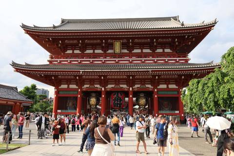       Grand red entrance gate of Senso-ji Temple bustling with crowds of visitors
  