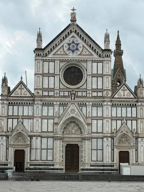       Detailed façade of Santa Croce Basilica with Gothic marble patterns.
  