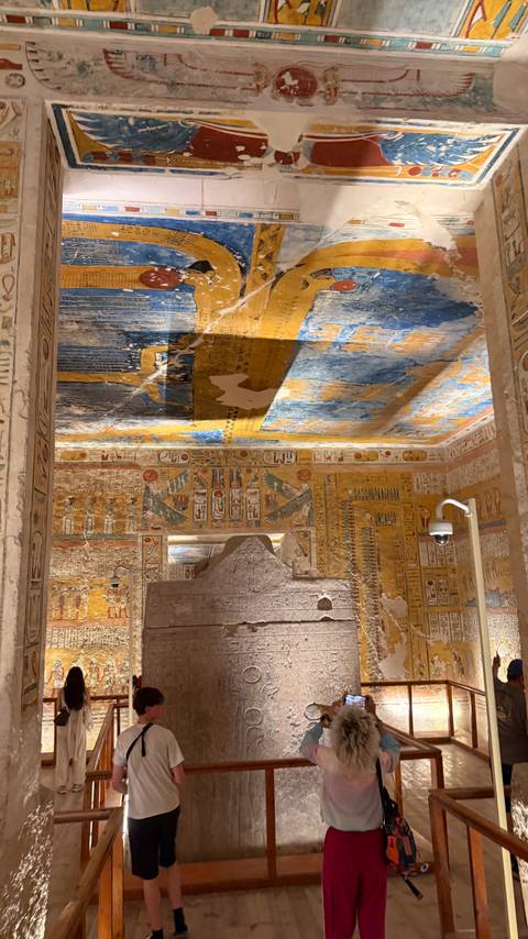       Vividly painted hieroglyphic ceiling and walls inside a royal tomb chamber.
  