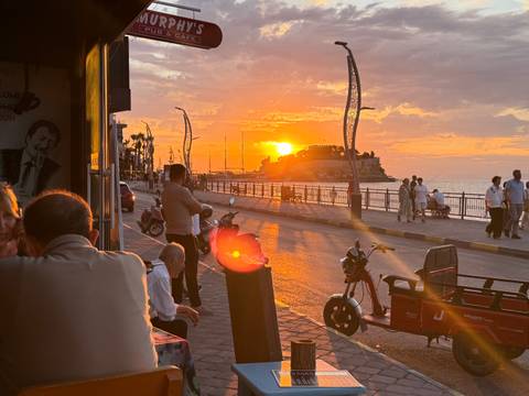       Duplicate sunset street scene on Kusadasi promenade overlooking the Aegean.
  