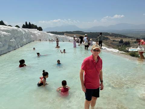       Visitors wade in the turquoise thermal pools of Pamukkale’s travertine terraces.
  