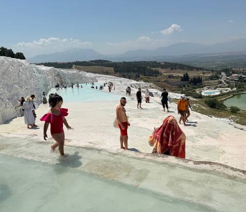       Crowds explore Pamukkale’s blinding white terraces and warm mineral pools.
  