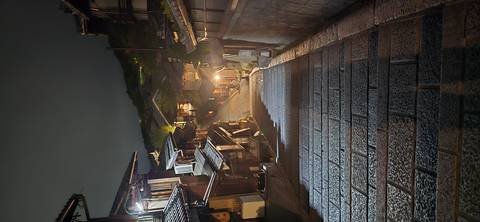       Steep stone stairway descending through softly lit traditional wooden houses in Kyoto at night.
  