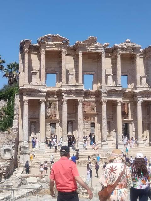       Facade of the ancient Library of Celsus with tourists gathered below
  
