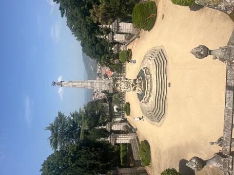       Baroque monument fountain on terraced sanctuary grounds overlooking valley
  