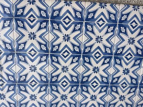       Close-up pattern of traditional blue and white Portuguese ceramic tiles
  