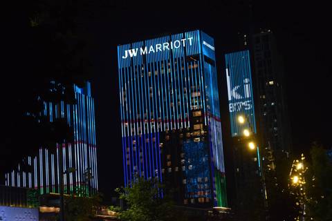       Night view of illuminated JW Marriott skyscraper with colorful LED stripes in Tashkent
  