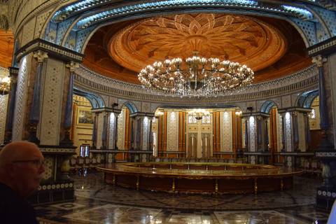       Lavish chandelier-lit circular hall inside Turkmenistan palace with intricate tilework and wood ceiling
  