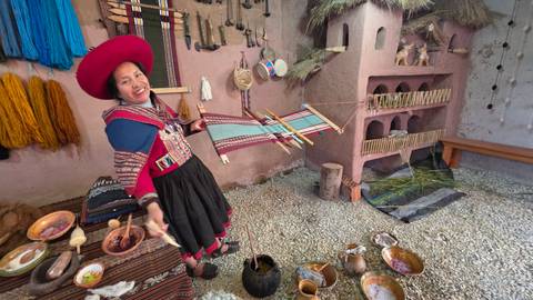       Andean woman demonstrating traditional weaving techniques in a colourful craft room.
  
