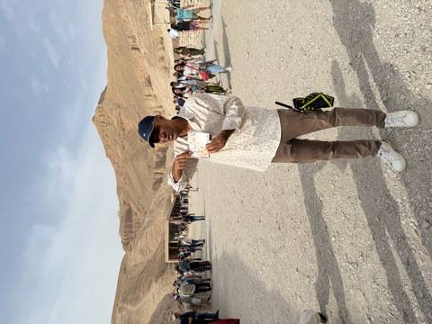       Tour guide explaining at the Valley of the Kings surrounded by tourists
  