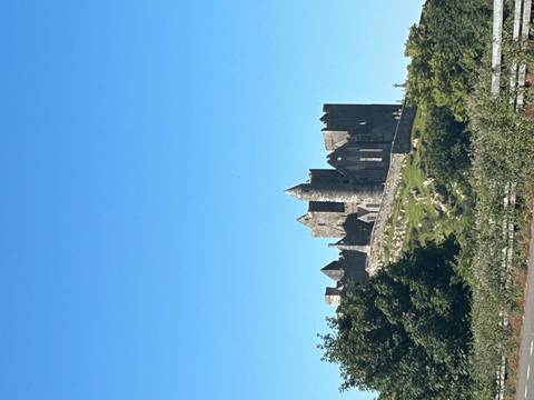       The medieval Rock of Cashel perched on a green hill beneath a clear Irish sky
  