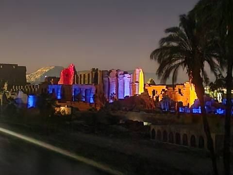       Ancient temple ruins in Luxor illuminated with colored lights during a night show
  