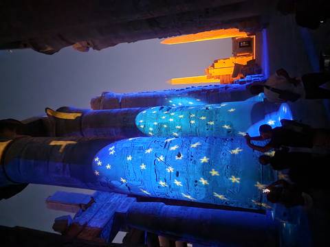       Nighttime light projection of stars on massive hieroglyphic columns inside Karnak Temple
  