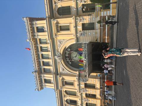       Tourists photograph the ornate façade and clock of Saigon’s Central Post Office.
  