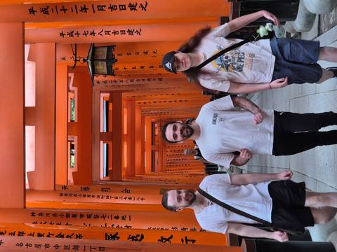       Travellers walk through the famous vermilion torii tunnel at Fushimi Inari Shrine.
  