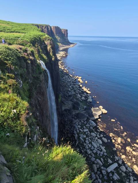       Dramatic Mealt Falls plunges from green cliffs of Kilt Rock into the deep-blue sea.
  