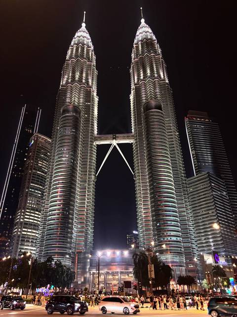       Illuminated Petronas Twin Towers soaring into the night sky
  