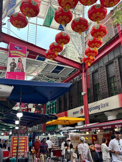       Decorated Chinatown street with red lanterns, signage and shopfronts in Kuala Lumpur
  