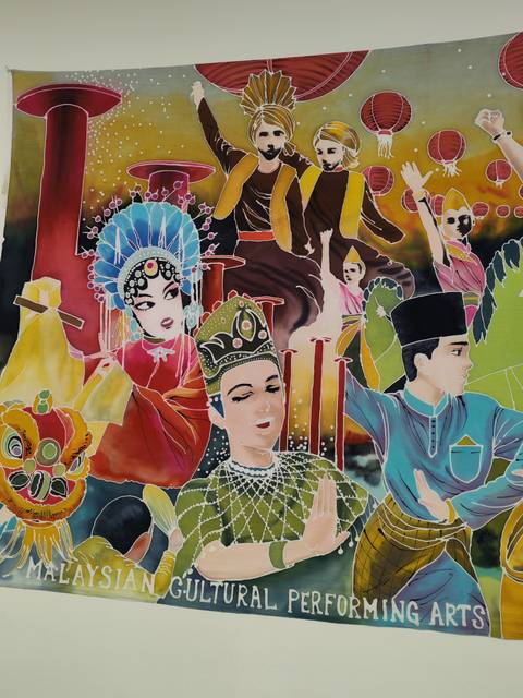       Colourful mural depicting multicultural Malaysian performers in traditional attire.
  