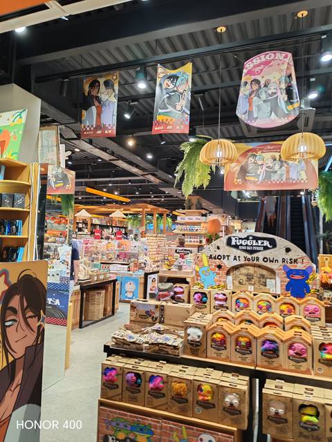       Brightly lit indoor souvenir and toy shop packed with colorful merchandise.
  