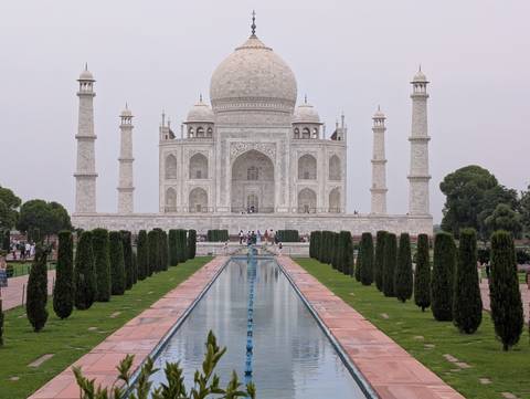       Centered view of the Taj Mahal and its reflecting pool on a hazy afternoon.
  