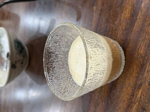       Clear glass showing layers of Vietnamese egg coffee foam and robust brew inside.
  