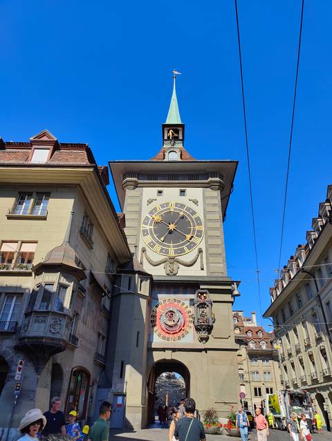       Historic Zytglogge clock tower with ornate astronomical clock against clear blue sky.
  