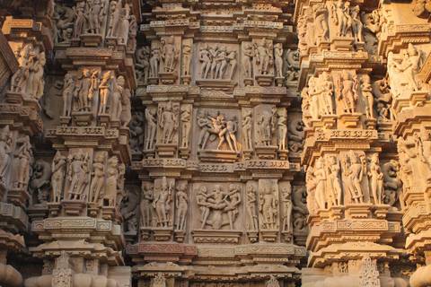       Intricate erotic sandstone sculptures depicting mythological figures on the walls of Khajuraho Temple.
  