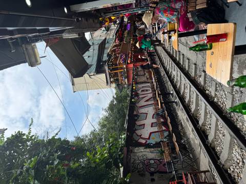      Cafés line the famous Hanoi Train Street where narrow railway tracks run past outdoor seating.
  