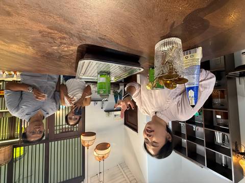       Guide passionately explaining coffee making to two attentive travelers inside a workshop.
  
